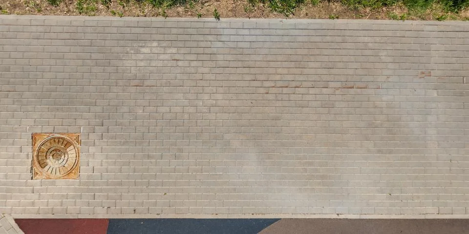 Top view of surface of pedestrian path with paving slabs with the border of l Stock Photos