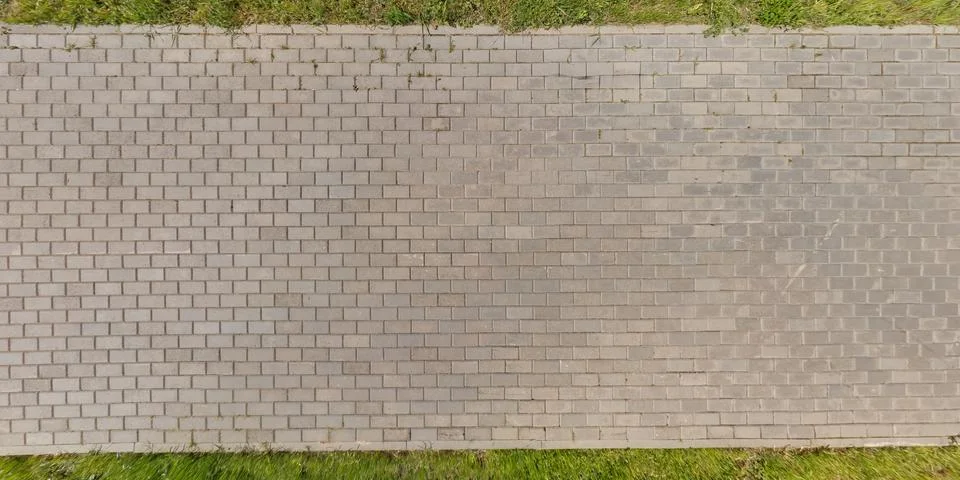Top view of surface of pedestrian path with paving slabs with the border of l 스톡 사진