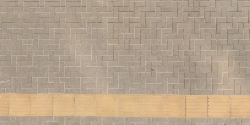 Top view of surface of pedestrian path with paving slabs with the border of l Stock Photos