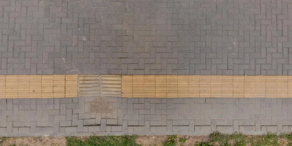 Top view of surface of pedestrian path with paving slabs with the border of l Stock Photos