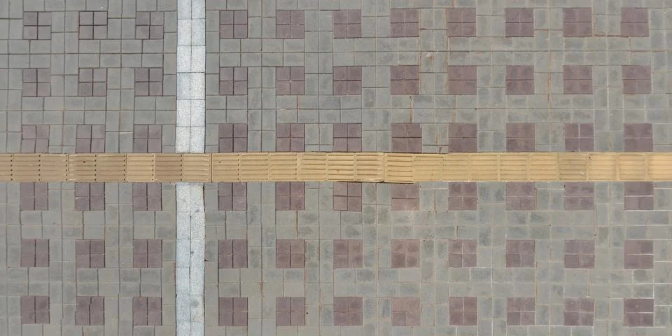 Top view of surface of pedestrian path with paving slabs with the border of l Stock Photos