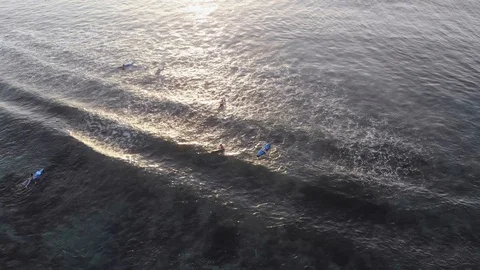 Top of view of surfers on the ocean at sunset and wave. Nature, water, sports Stock Footage 92949910