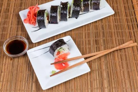 Top view of sushi on rectangular plates, condiments, chopsticks 스톡 사진