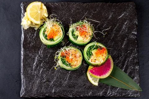 Top view sushi set with crab meat, red caviar, cucumber and micro greens Stock Photos