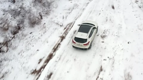 Top view of an SUV driving along a snow-dusted mountain road Stock-Footage 269097975