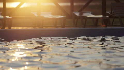 Top view of swimming pool with clear water on vacation on sunset background Stock Footage 178597904