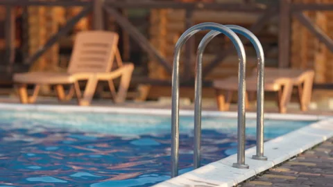 Top view of swimming pool with clear water on vacation on sunset background Stock Footage 204779783