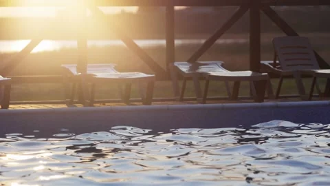 Top view of swimming pool with clear water on vacation on sunset background Stock Footage 348023949