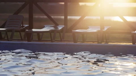 Top view of swimming pool with clear water on vacation on sunset background Stock Footage 348402426