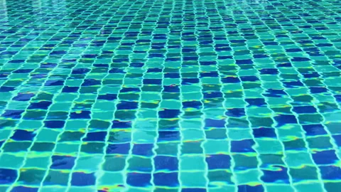 Top view of swimming pool water surface with blue tiled bottom texture. Stock Footage 344673125