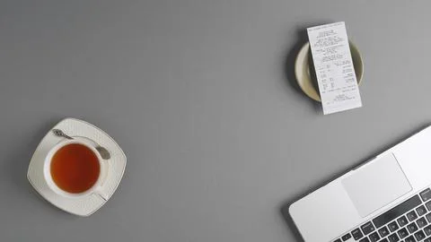 Top view of a table in a cafe or restaurant with a check resting on a saucer Stock Photos