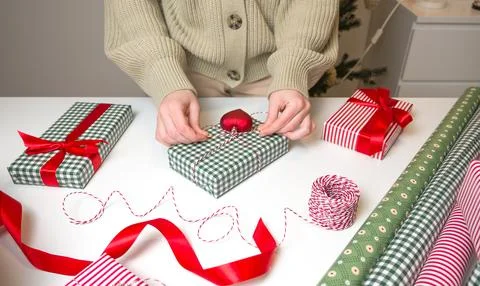 Top view on table with christmasgift boxes. Woman wrapping and decorating pre Stock Photos