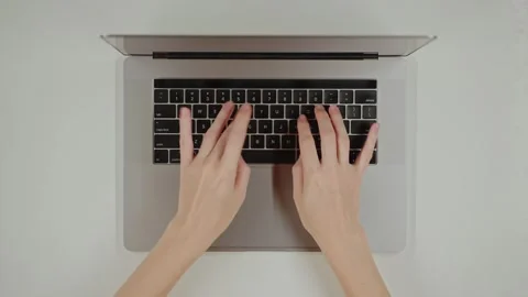 Top view table Close-up Female hands typing prompt on a keyboard laptop using AI Stock Footage 281573197