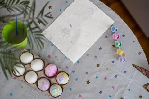 Top view of table with Easter eggs and paint. Christian spring holiday and Stock Photos