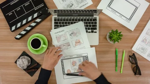 Top view of a table. The hands of the man who keeps the advertising storyboards 스톡 동영상 77218603