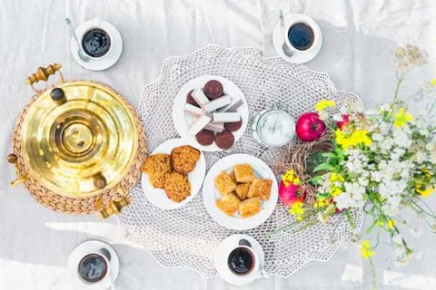 Top view of a table laid with samovar, coffee cups, sweets Stock Photos