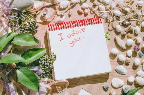 Top view on the table. Note to the Valentine's Day. Love letter. I adore you. Stock Photos
