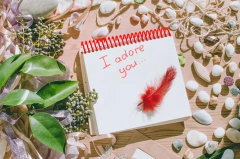 Top view on the table. Note to the Valentine's Day. Love letter. I adore you. Stock Photos