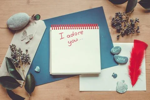 Top view on the table. Note to the Valentine's Day. Love letter. I adore you. Stock Photos