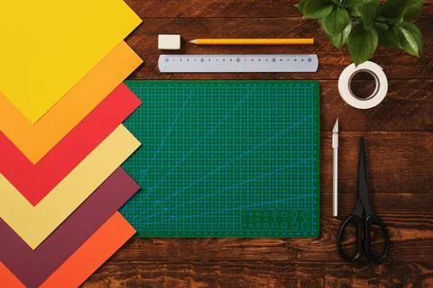Top view of table for paper crafts. Crafting tools. Neatly arranged sheets .. Stock Photos