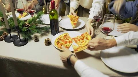 Top view of a table with pizza in a plate, the hands of a group of friends are Stock Footage 167246242