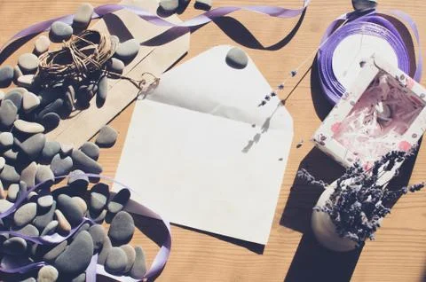 Top view on the table. Romantic desk. Notebook, sea stones, design items. Stock Photos