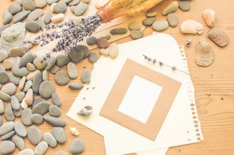 Top view on the table. Romantic desk. Notebook, sea stones, design items. Stock Photos
