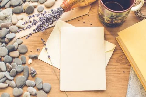 Top view on the table. Romantic desk. Notebook, sea stones, design items. Stock Photos