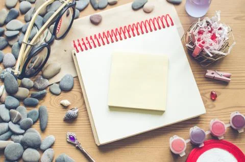 Top view on the table. Romantic desk. Notebook, sea stones, design items. Foto stock