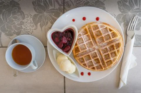 Top view of table setting with belgian waffles, ice cream and jam with tea Stock Photos