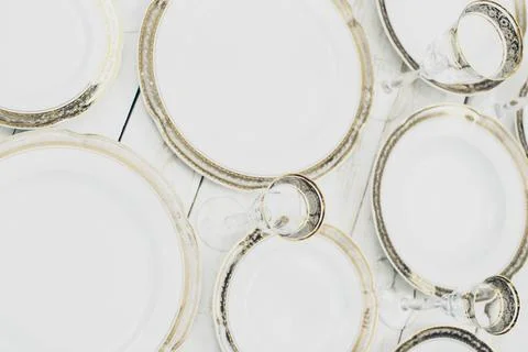 Top view of table setting with plates and tableware on white background Stock Photos