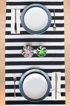 Top view of table setting for two. Minimalistic decoration with succulent f.. Stock Photos
