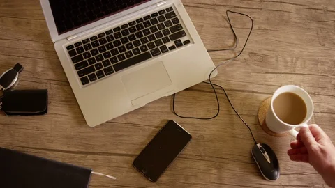 Top view of table . Smartphone with a green screen and coffee cup inside office Stock Footage 123620443