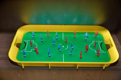 Top view table soccer with red blue players and a ball. Foosball table. Top v Stock Photos