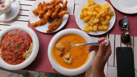 Top view of table at Spanish restaurant, woman take spoon of cold soup 스톡 동영상 102283850