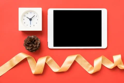 Top view of tablet clock and gold ribbon Stock Photos