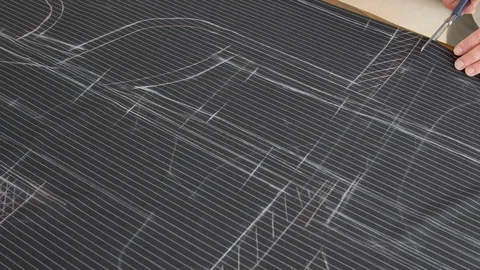 Top view of tailor hands working with scissor and suit textile cloth. Tailor at Stock Footage 127219629