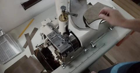 Top view of tailor thinning leather piece with leather skiving machine passing Stock Footage 200127162