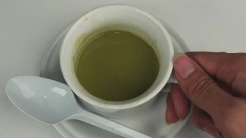 Top view of take and put a glass of matcha or green tea on saucer Stock Footage 278030972