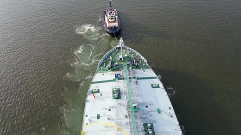 Top view of a tanker being assisted by a tugboat in a harbour Stock Footage 291591936