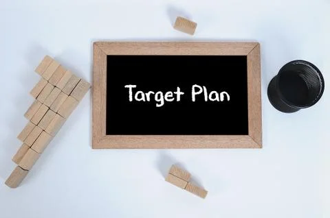 Top view of TARGET PLAN handwritten with white chalk on a blackboard.Pencil c Stock Photos