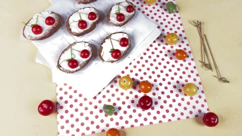 Top view of tartines with cherry tomato decoration on a yellow background and po Vidéo 304459078