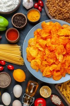 Top view tasty pepper cips with different seasonings and ingredients on dar.. 写真素材