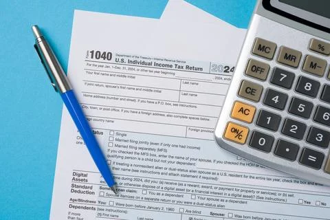 Top view of tax forms, calculator and pen on blue table Stock Photos