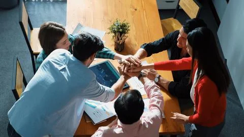 Top view of team putting hands together while drawing mind map. Convocation Stock Photos