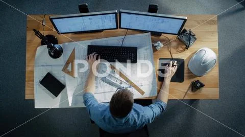 Top View of a Technical Engineer Working on His Blueprints, Drawing Plans Stock Photos