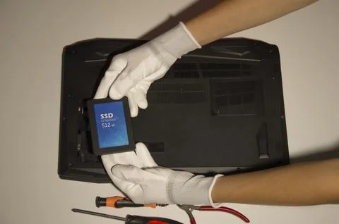Top view. Technician changing hard disk, SSD, high speed hard disk. Stock Photos
