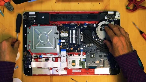 Top view of the technician engineer repair laptop unscrews the radiator for Stockbeeldmateriaal 113462488