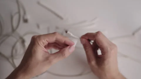 Top view of technician hands fixing damaged charging cable connector, surrounded Stock Footage 317306840