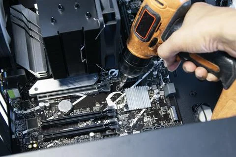 Top view of technician installing computer motherboard Stock Photos